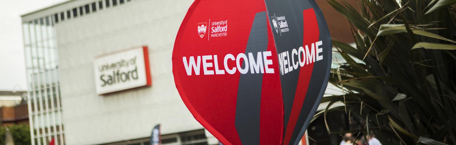 Welcome spinner signage at the University of Salford