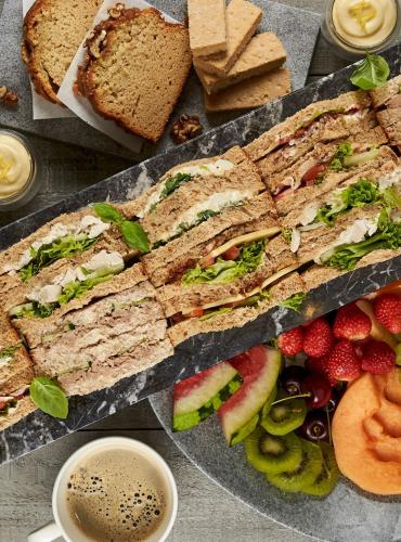 Hospitality platter with a selection of sandwiches, fruit and coffee