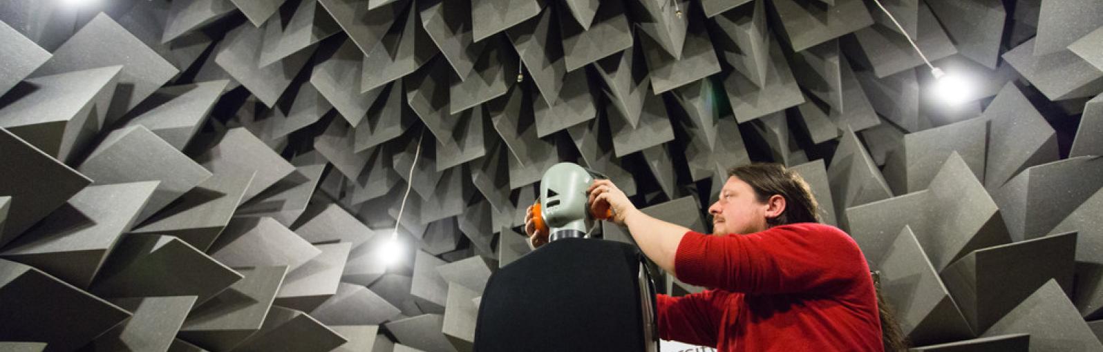 Student setting up an experiment in the anechoic chamber, University of Salford
