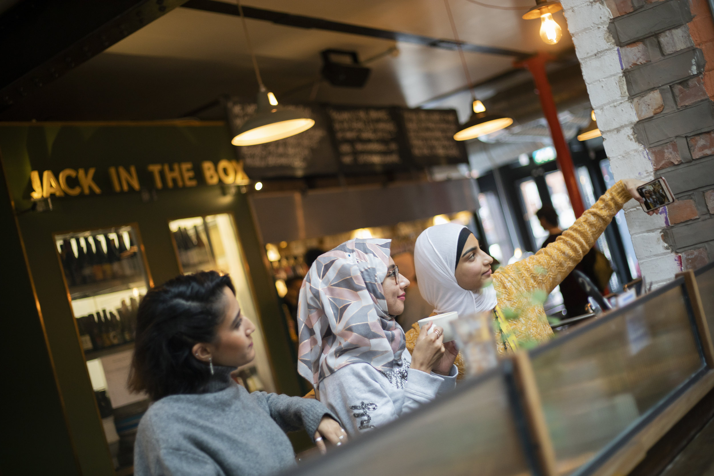 Students taking a selfie in Mackie Mayor market, Manchester