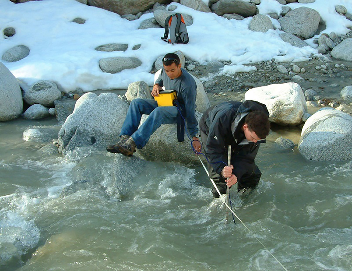 Geography students in a river in the Alps