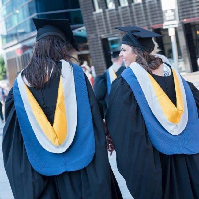 Graduands wearing gowns and mortar boards