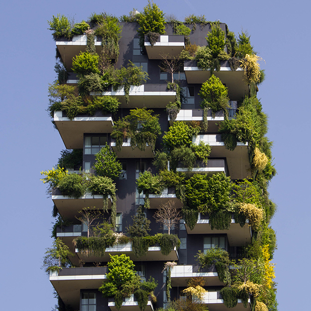 Tall building growing plants and greenery on the exterior
