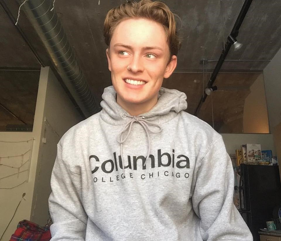 Male student wearing a grey Columbia College Chicago hoodie