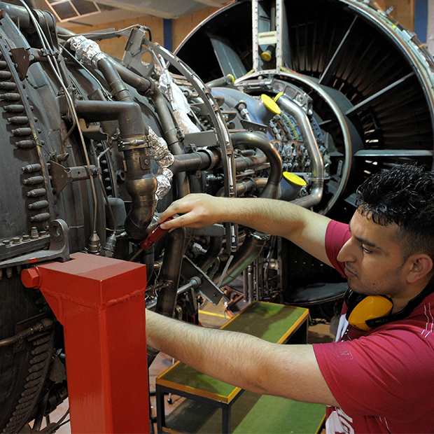 A student working on a aeroplane engine