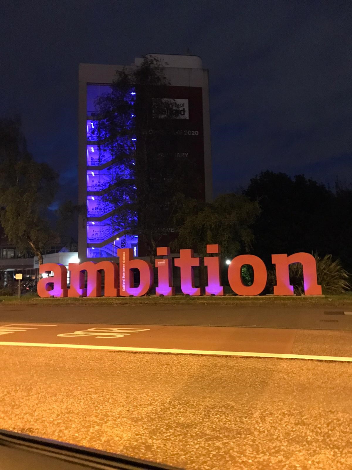 Maxwell Building at night with ambition sign