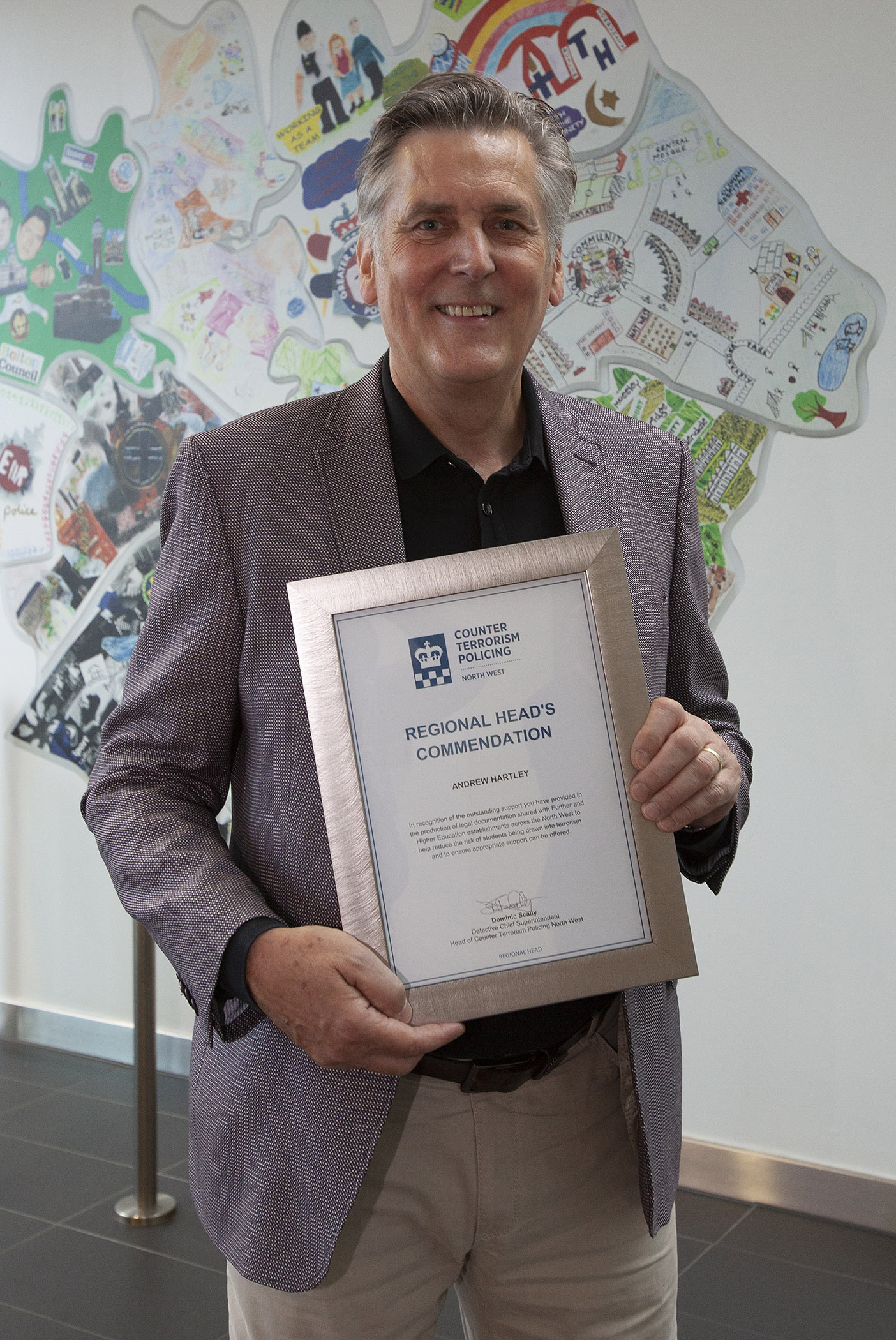 Andrew Hartley receives his award at GMP HQ