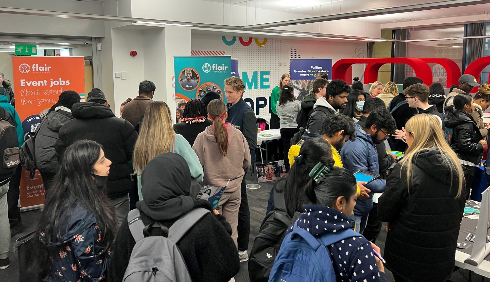 a picture of lots of students filling a room full of employers at the careers fair.