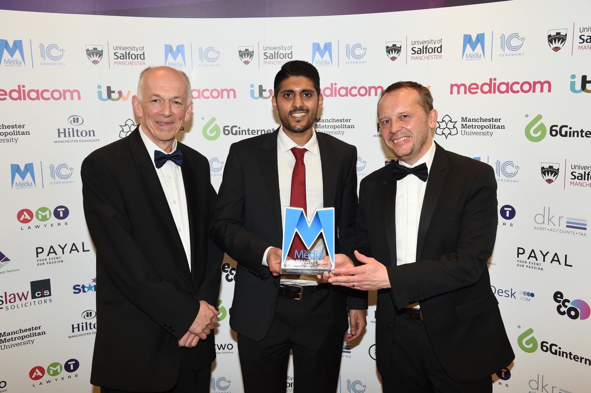 Issan Khan presented with his award by Professor Allan Walker and Paul Broster of the University of Salford 