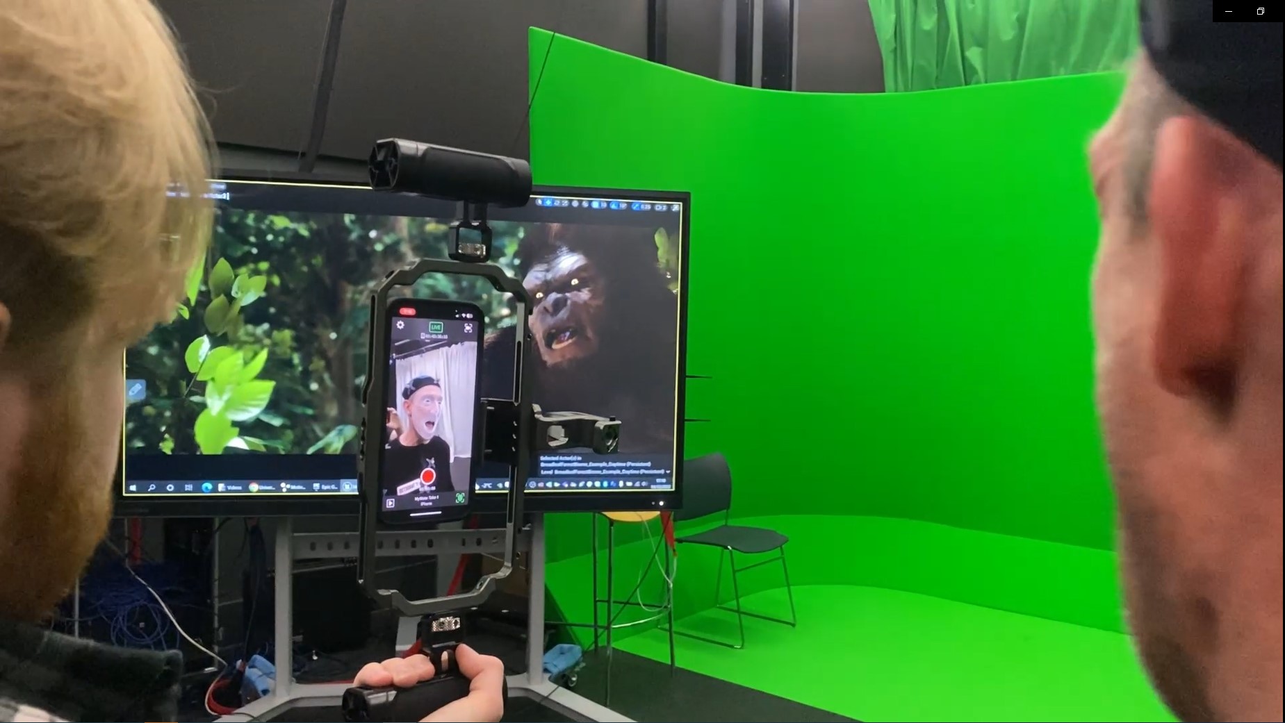 Screenshot taken from sizzle reel shows mocap performer next to green screen 