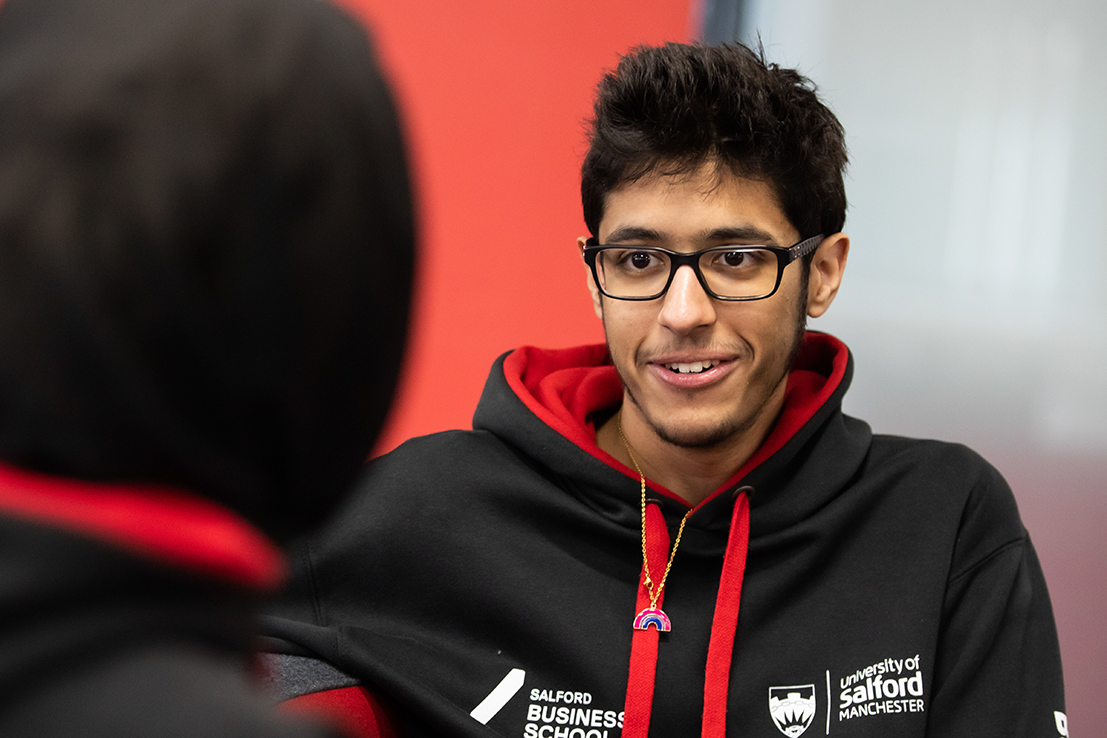 Student Humoud speaking with a student in Salford Business School