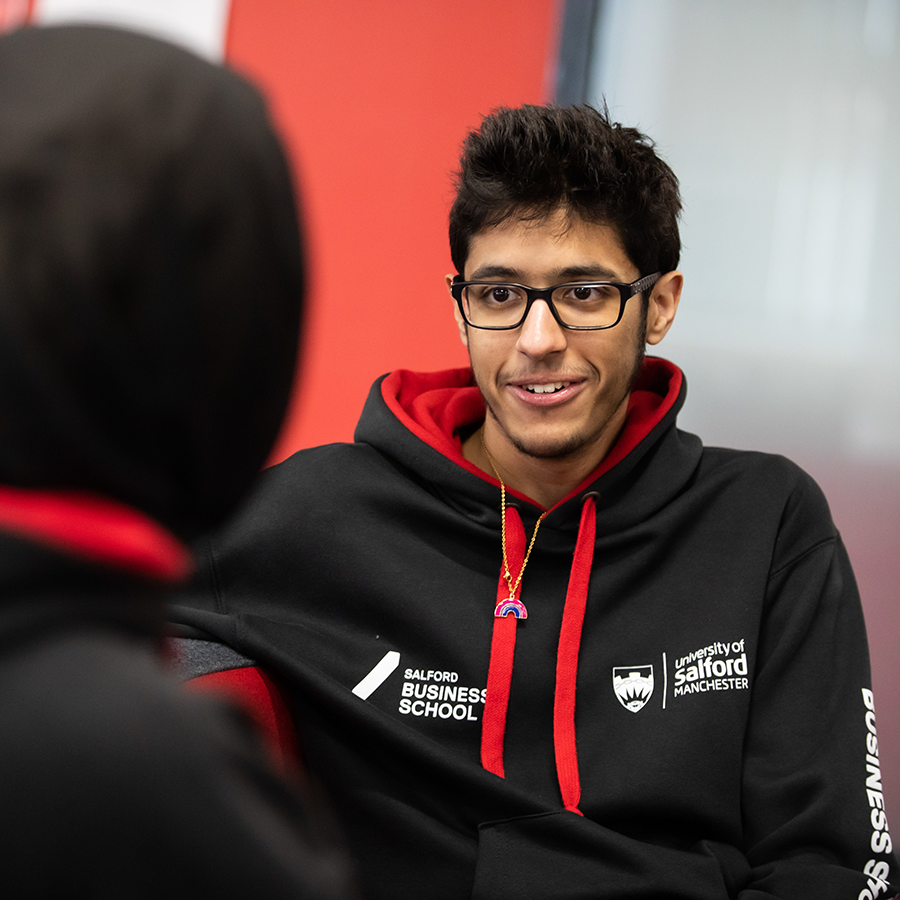 Student Humoud speaking with a student in Salford Business School