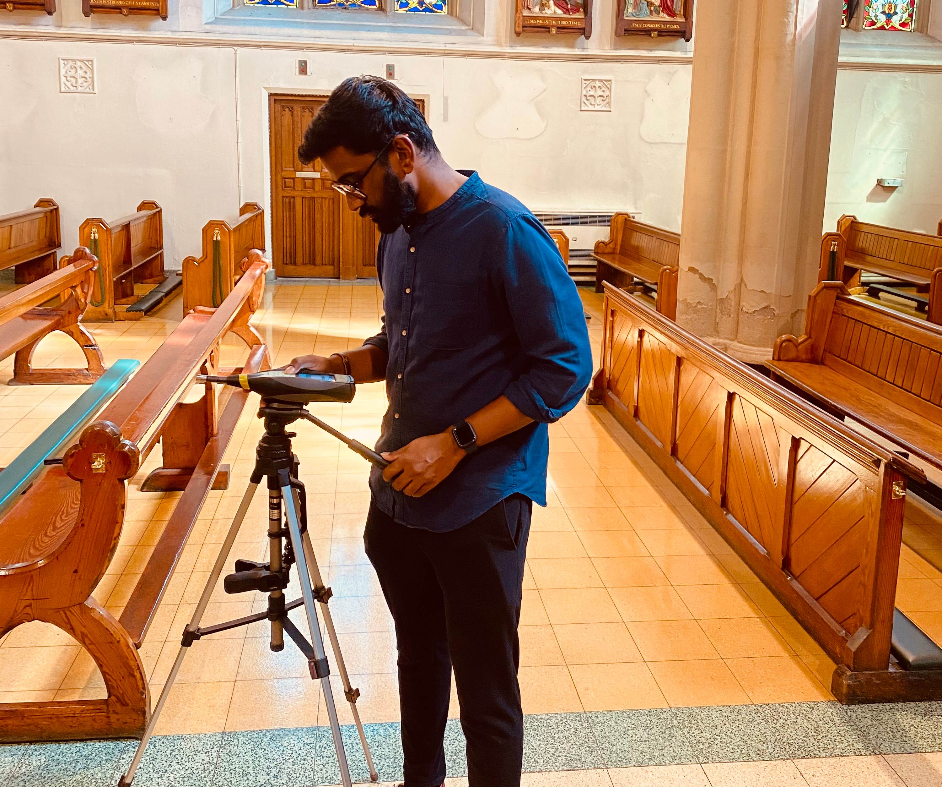 A man using equipment to test the acoustics in a Church