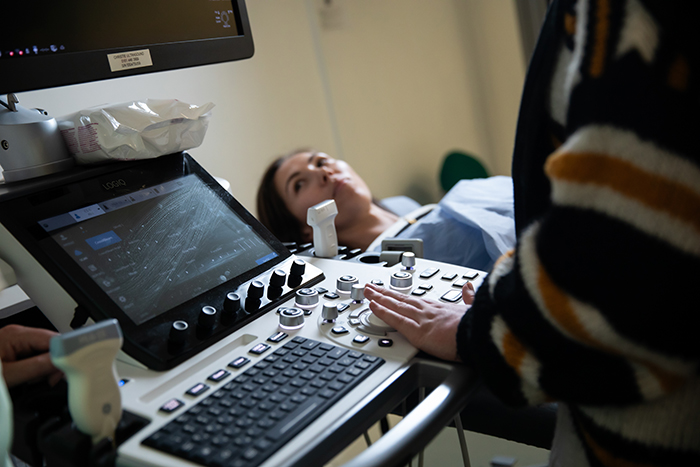 Students looking at screen and keyboard in the medical imaging suite 