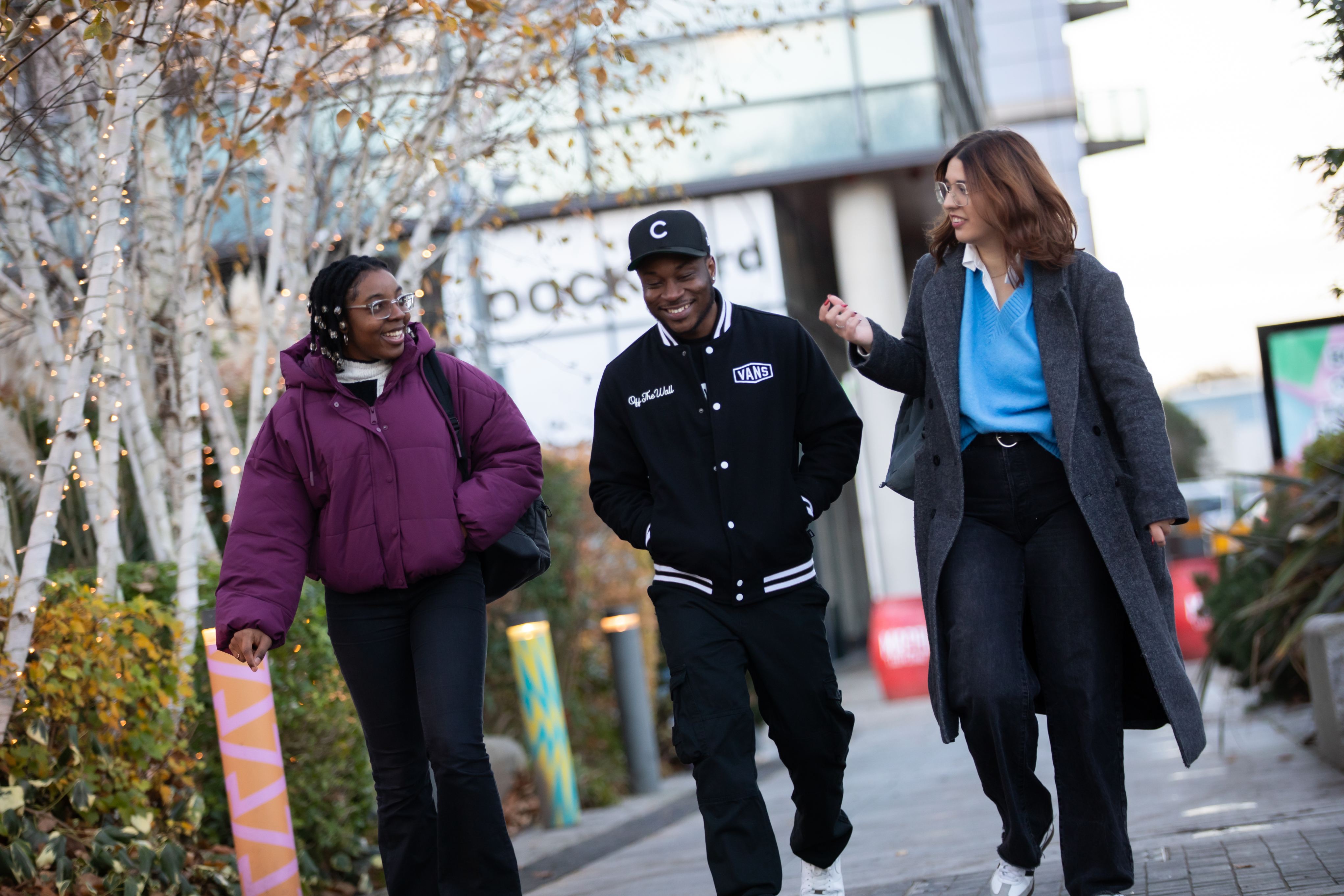 Three international students walking around MediaCity