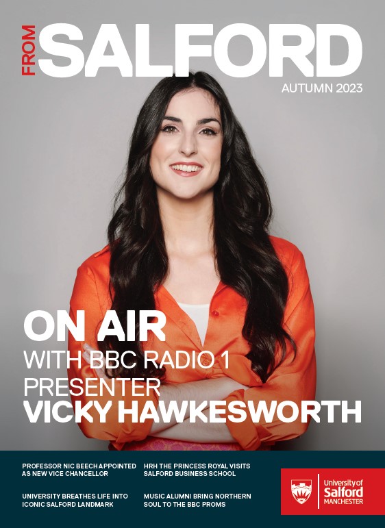 From Salford magazine 2023 front cover, featuring picture of Vicky Hawkesworth, Radio 1 DJ, stood arms folded in orange blouse