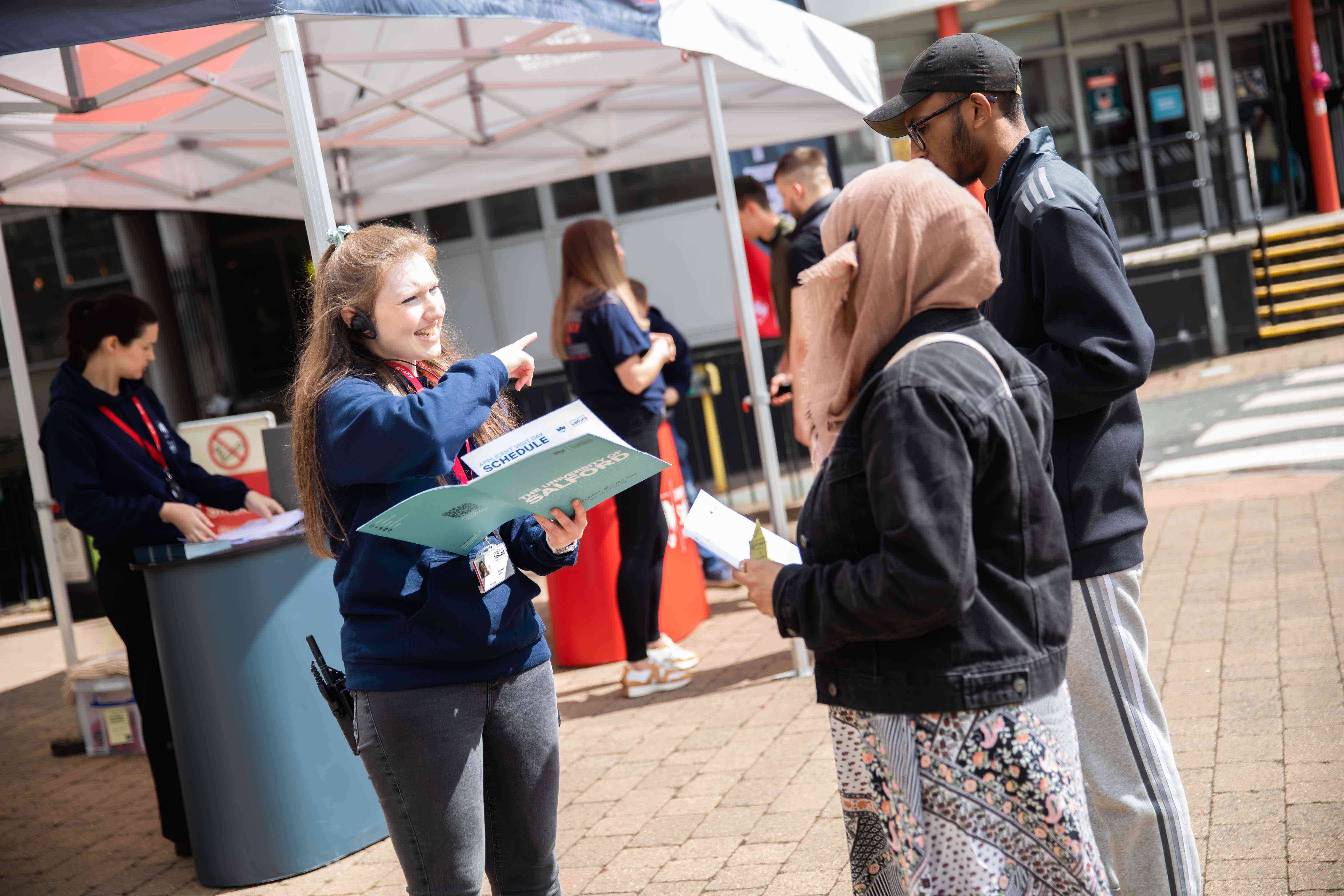Visitors receiving information booklet on open day 