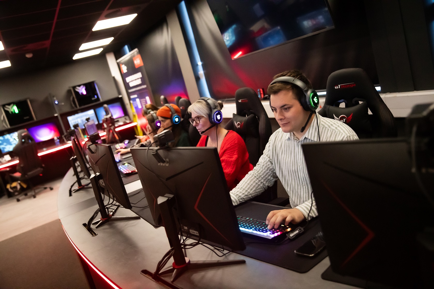 Staff using gaming workstations in the Esports Suite, Salford Business School