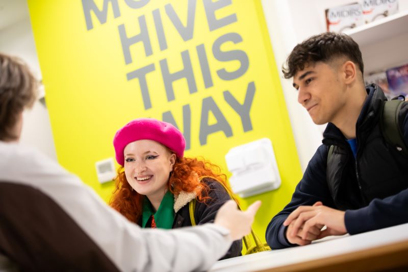 Two students consulting with an adviser