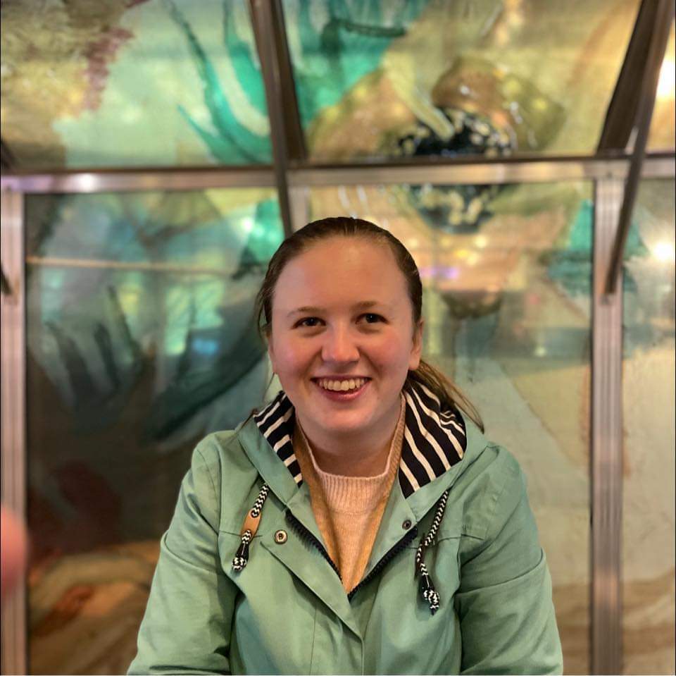 Wildlife Conservation student Charlotte, wearing a green coat, smiles for the photograph.