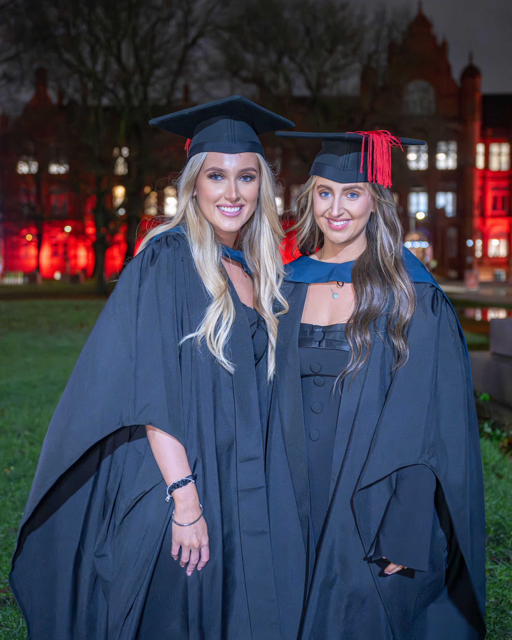 Graduates in graduation caps and gowns outside the Peel Building, University of Salford