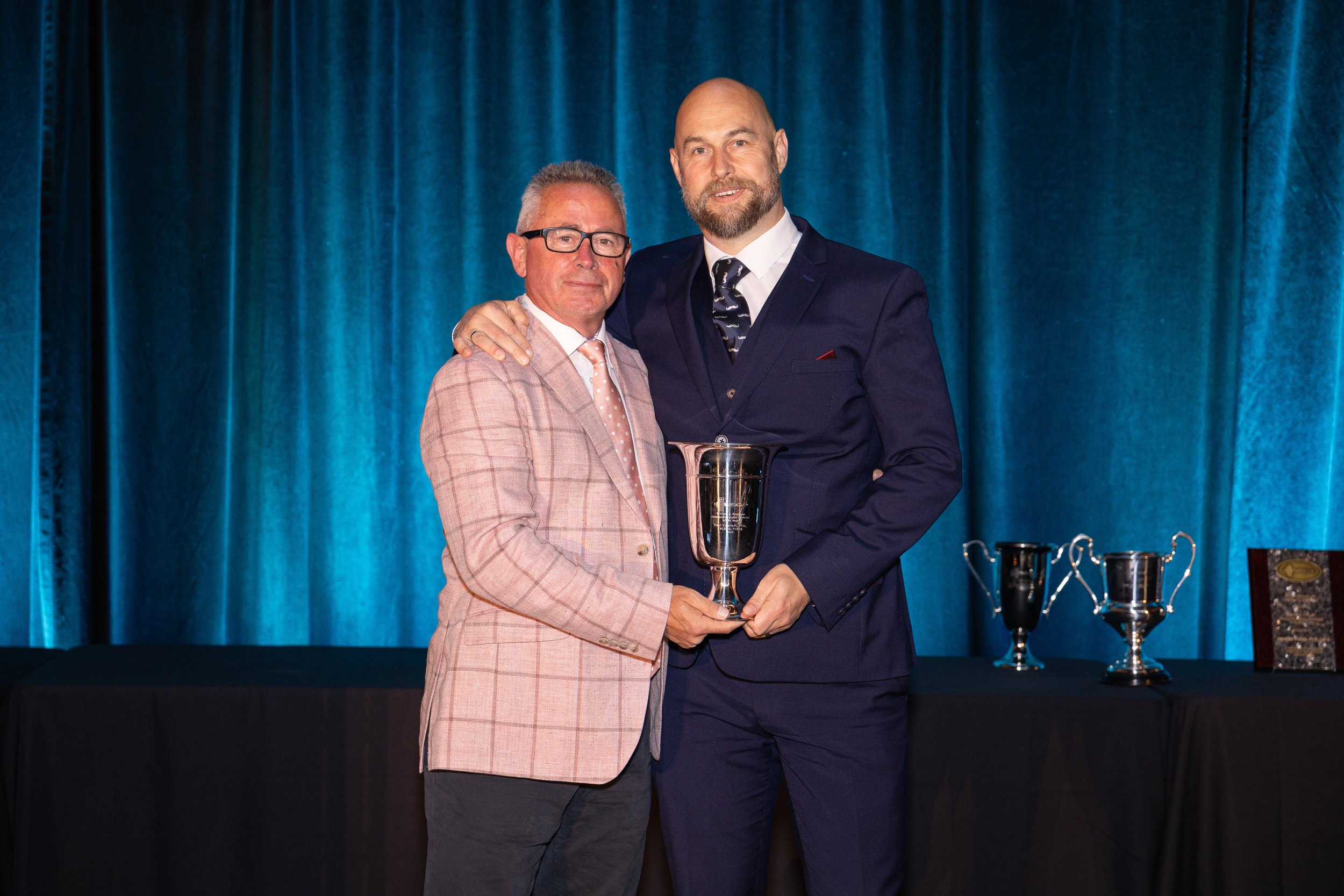 Professor Paul Comfort (right) receiving the 2025 William J. Kraemer Outstanding Sport Scientist Award from NSCA President Professor Ian Jeffreys