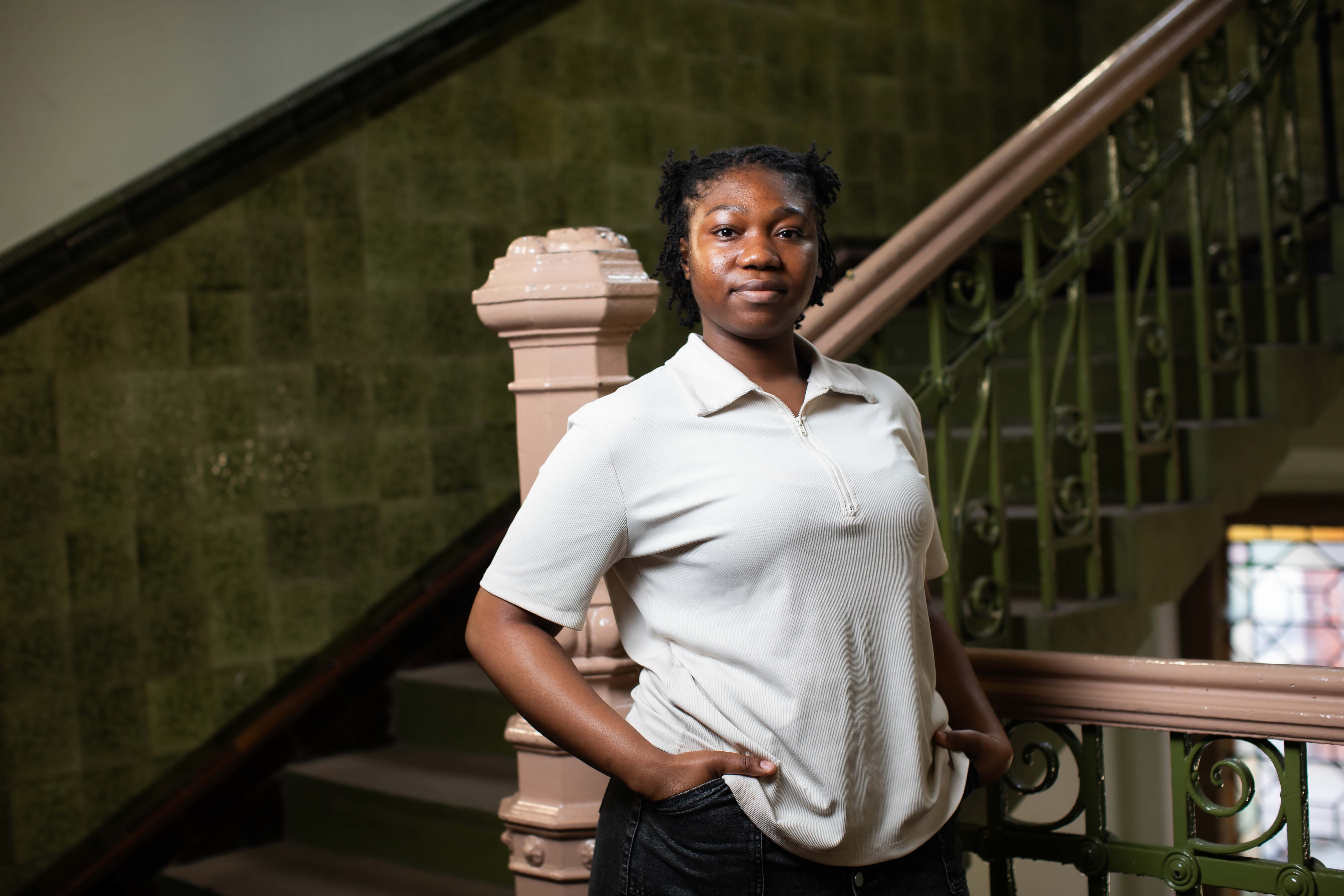 Law student Elizabeth is shown standing in the lobby of the peel building at the University of Salford