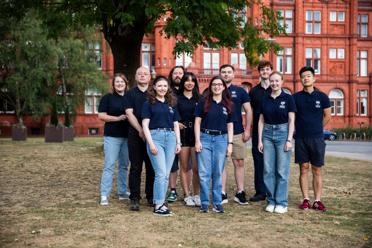 University of Salford recruitment team stood together outside Peel Building