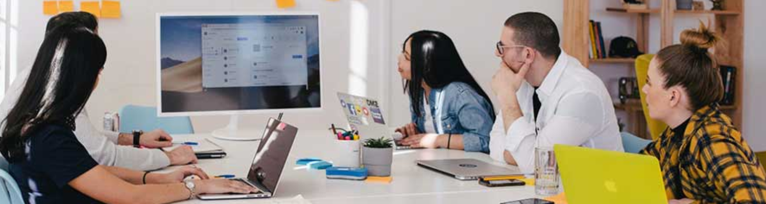 Students all sat looking at a screen around a desk