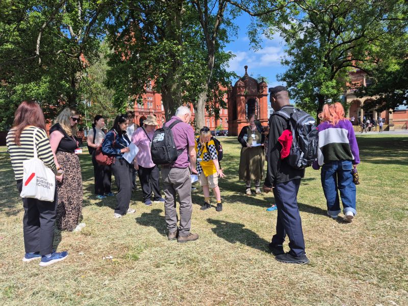 People on a walk through campus looking at the nature.
