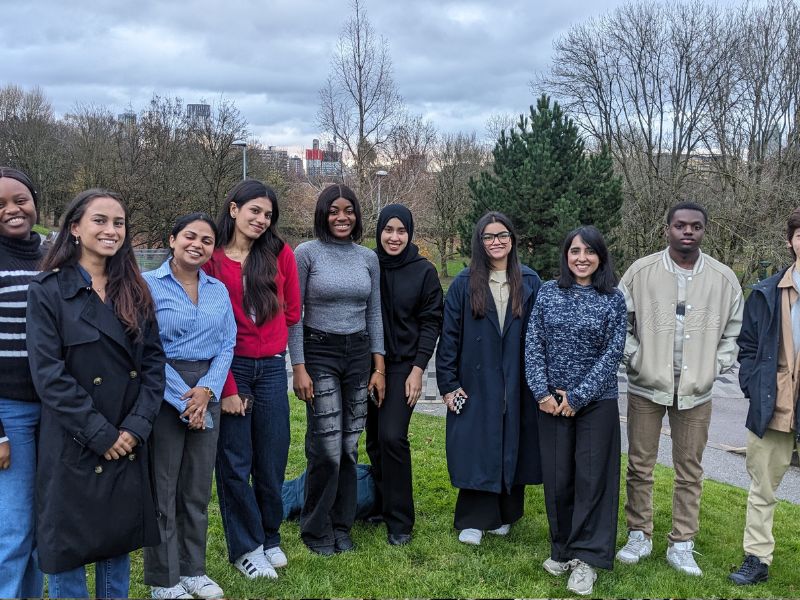 A group of people outside smiling.