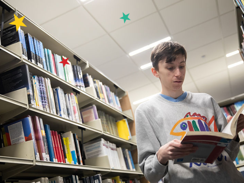 Student reading book in library