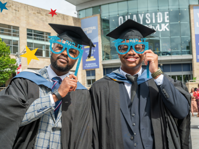 Graduates posing with glasses