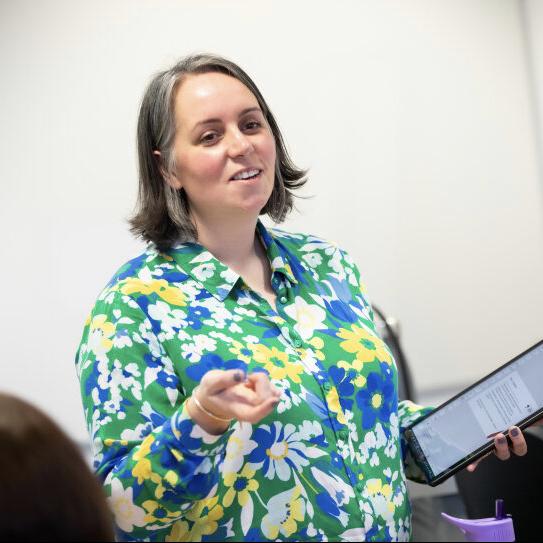 Miriam Collett holding a digital tablet