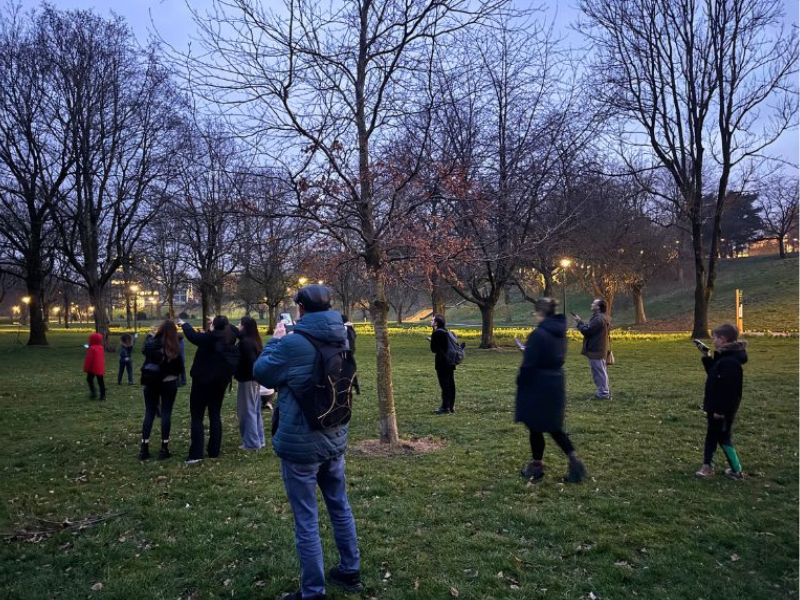 A group of people participating in an evening bat walk