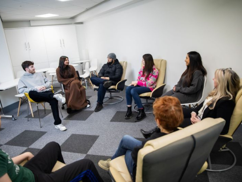 A group of seated people participating in a discussion session