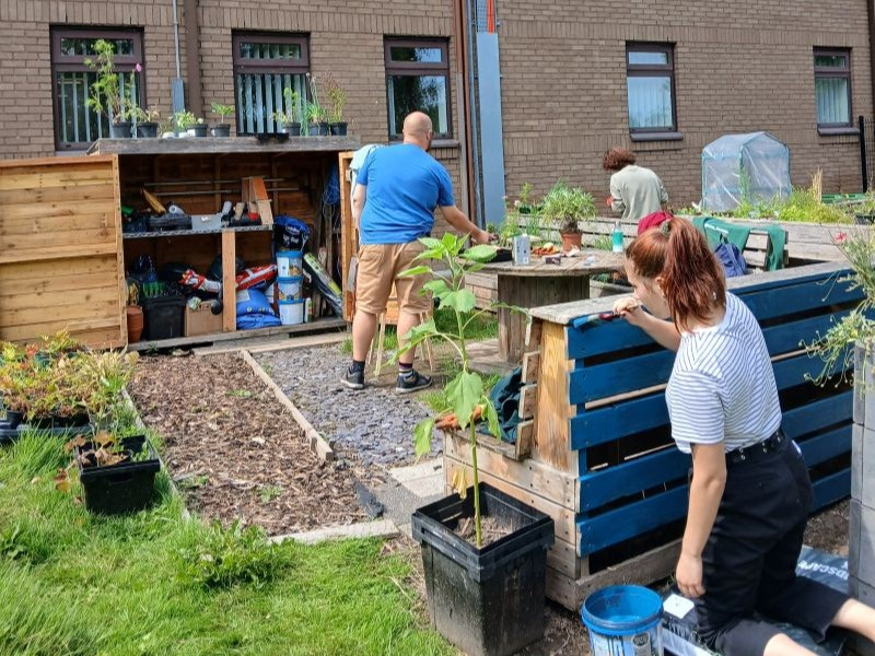 Volunteers working in the University of Salford community growing space behind the Clifford Whitworth library