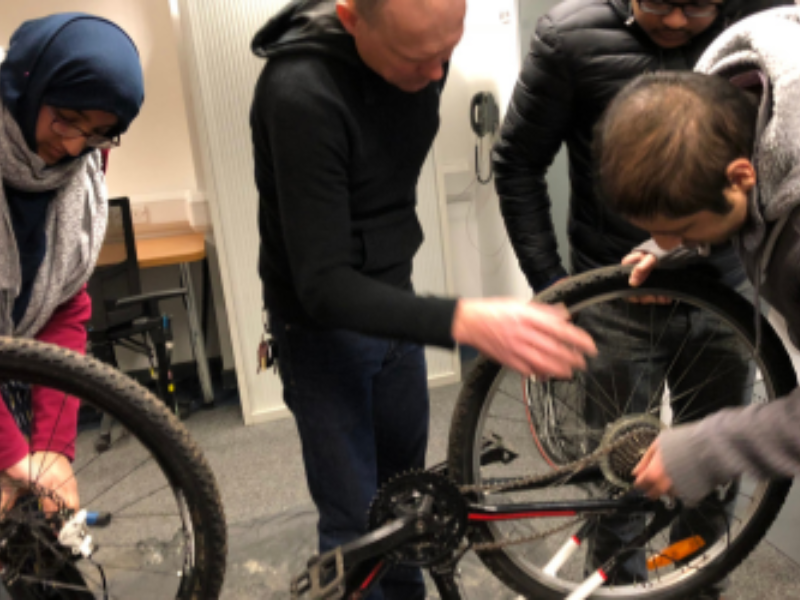 Group of participants learning basic bicycle maintenance and repair skills
