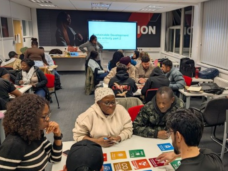 A group of students participating in an interactive Sustainable Development Goals (SDG) workshop session at the University of Salford