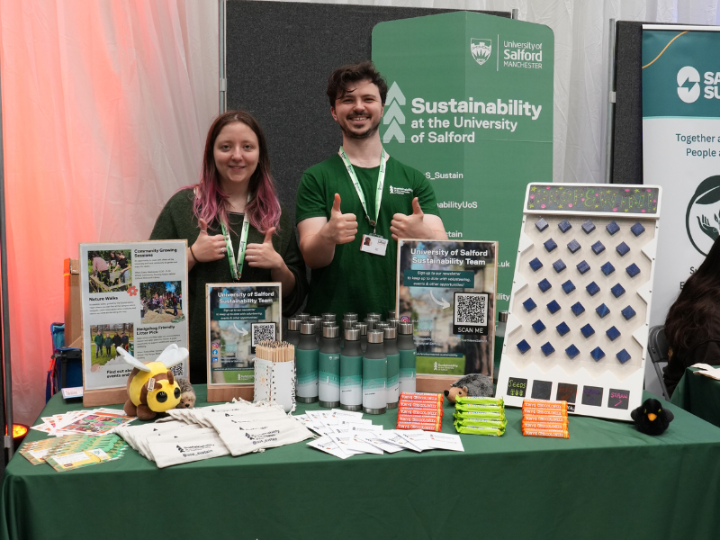 Two people staffing a pop up sustainability stall at the University of Salford