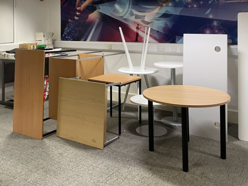 A collection of disused office furniture ready for recycling