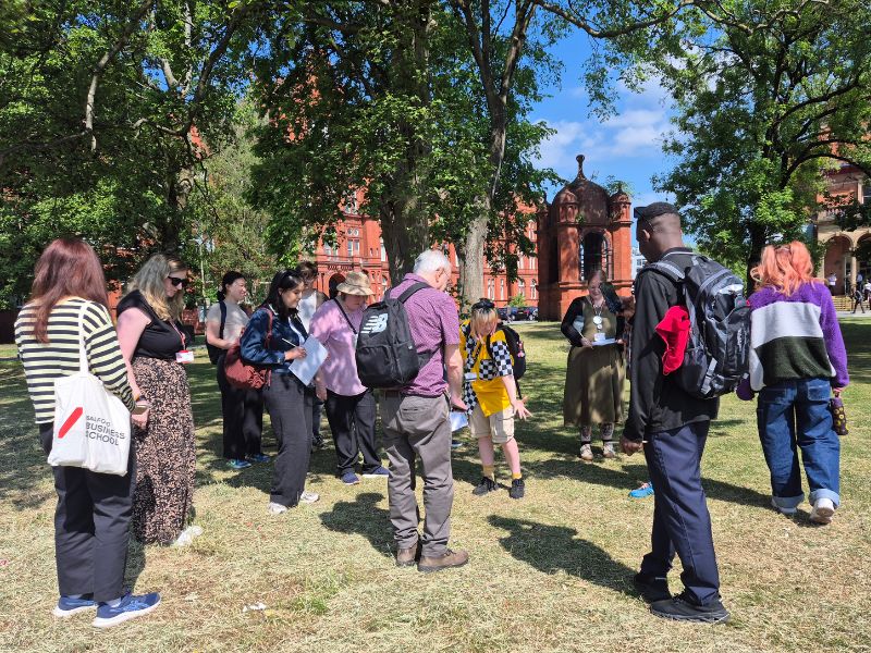 A group of people looking around for bees on their nature walk