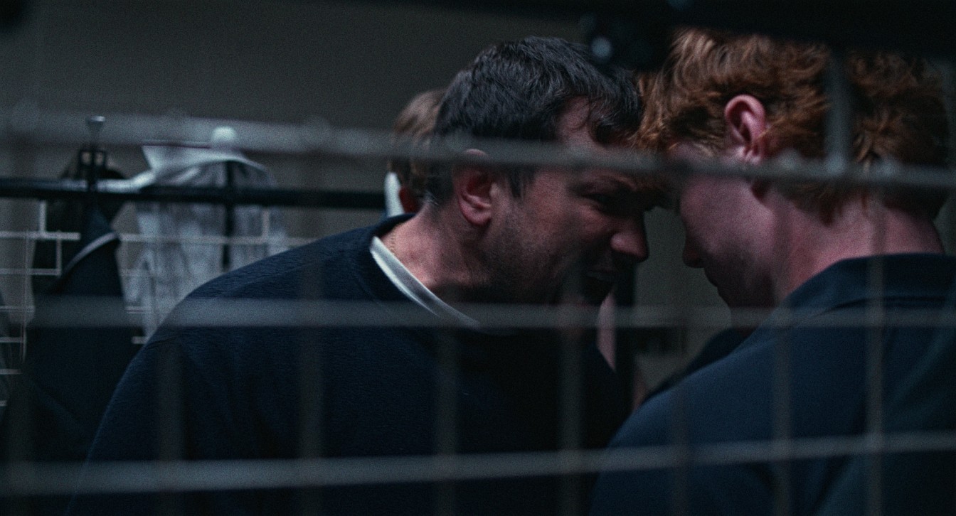 A man headbutts a student in a still from the film Dogbone