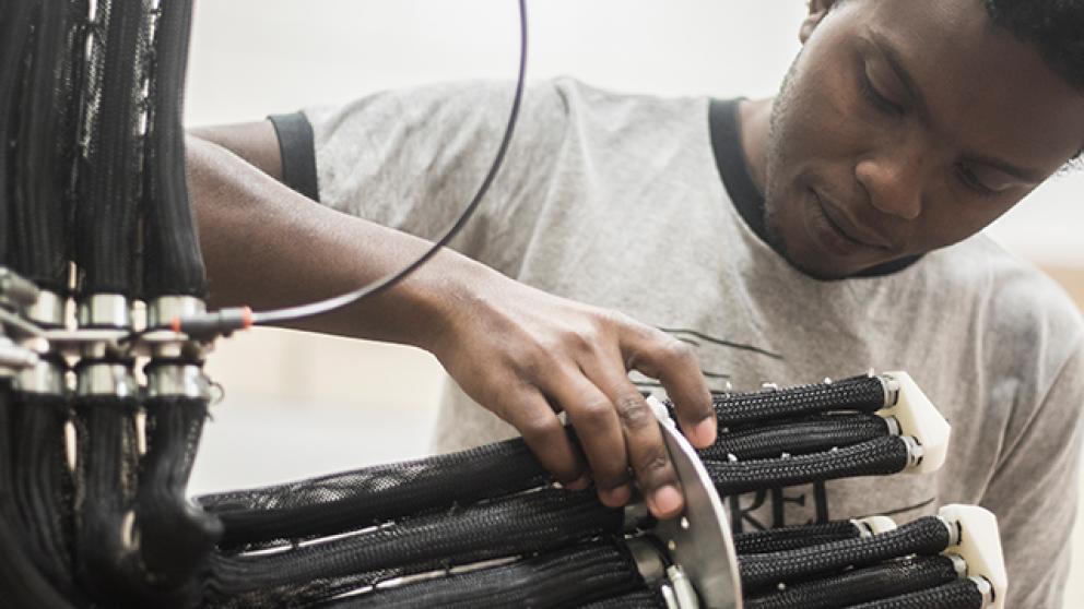 Researcher working on cabling
