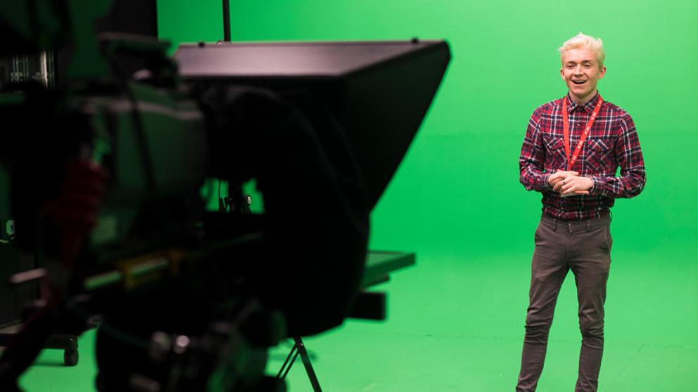 A camera filming a student against a green screen at MediaCity