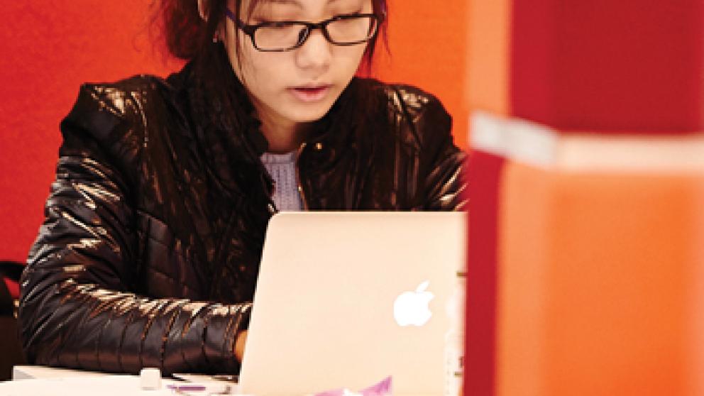 Student studying on their MAC laptop