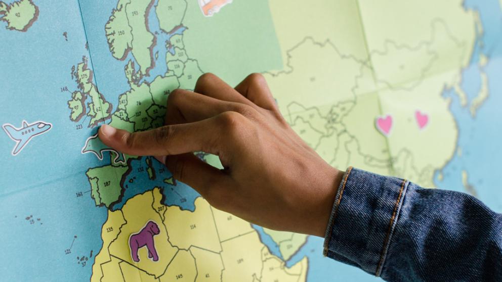 Woman pointing at a world map