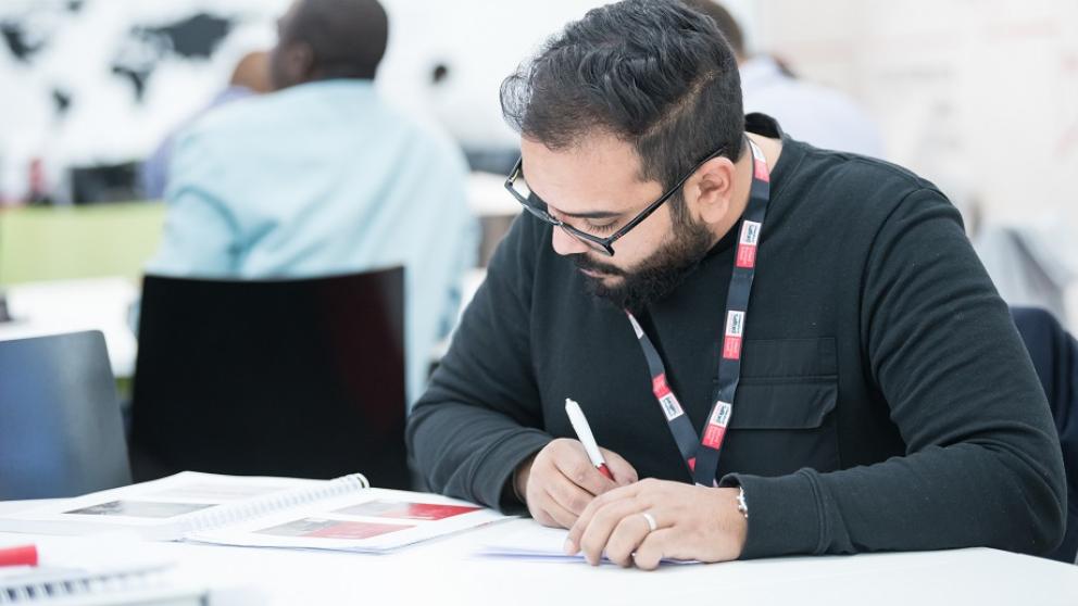 International postgraduate student taking notes
