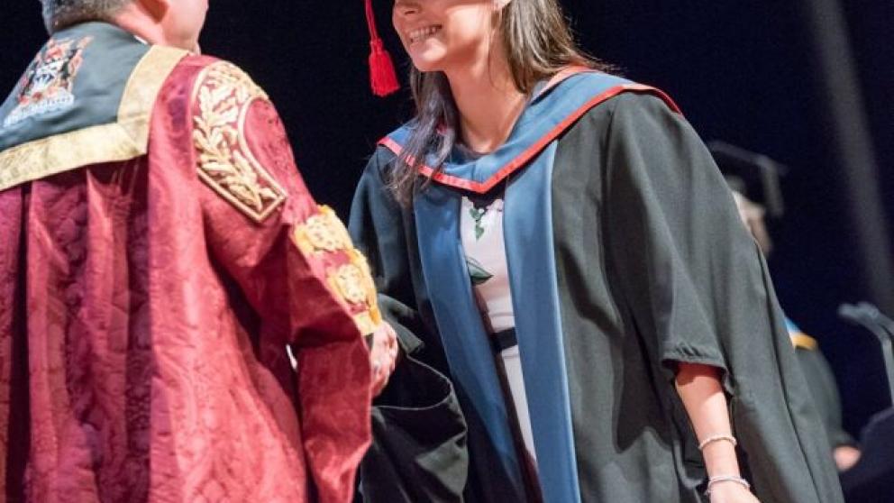 On stage during a student's graduation ceremony