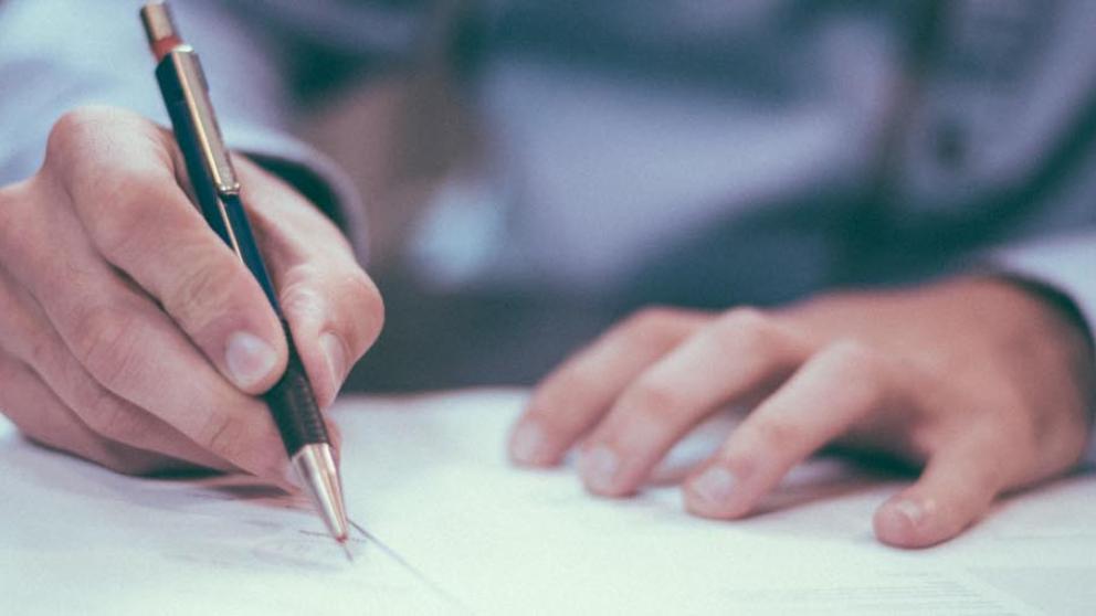 Lawyer at a desk working with pen and paper